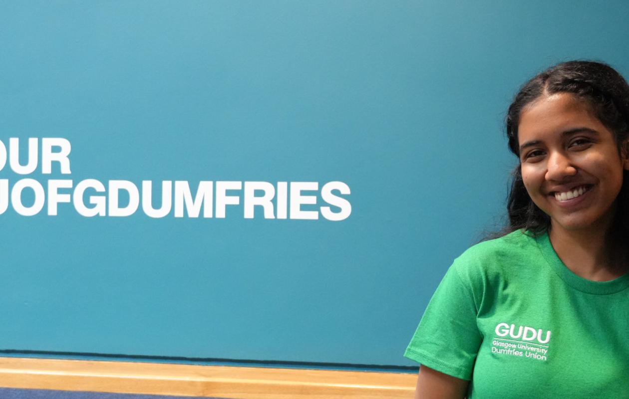 Student next to UofG Dumfries sign