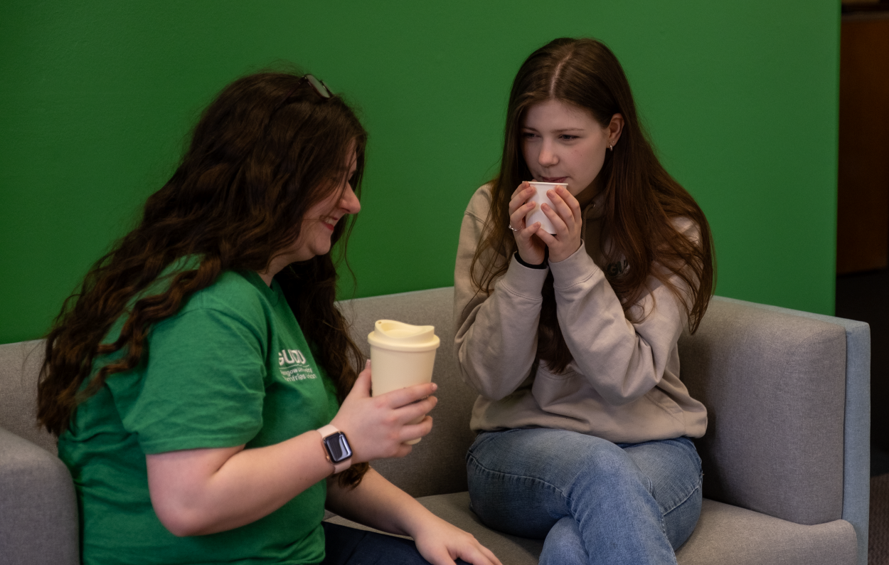 GUDU committee sitting in the hub with a complimentary hot beverage. 